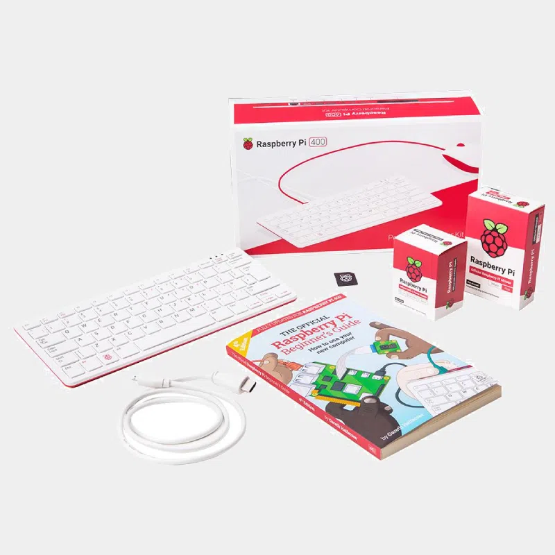 Kit Raspberry Pi 400, boîte ouverte avec clavier blanc, câble, carte SD et guide